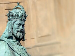 A statue of King Charles IV in Prague with wall background