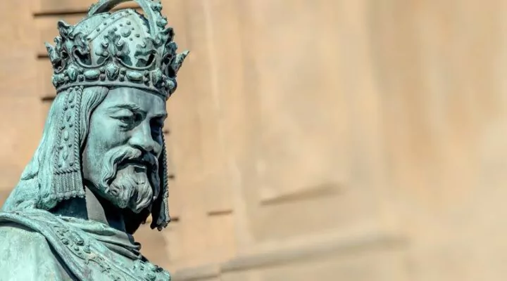 A statue of King Charles IV in Prague with wall background